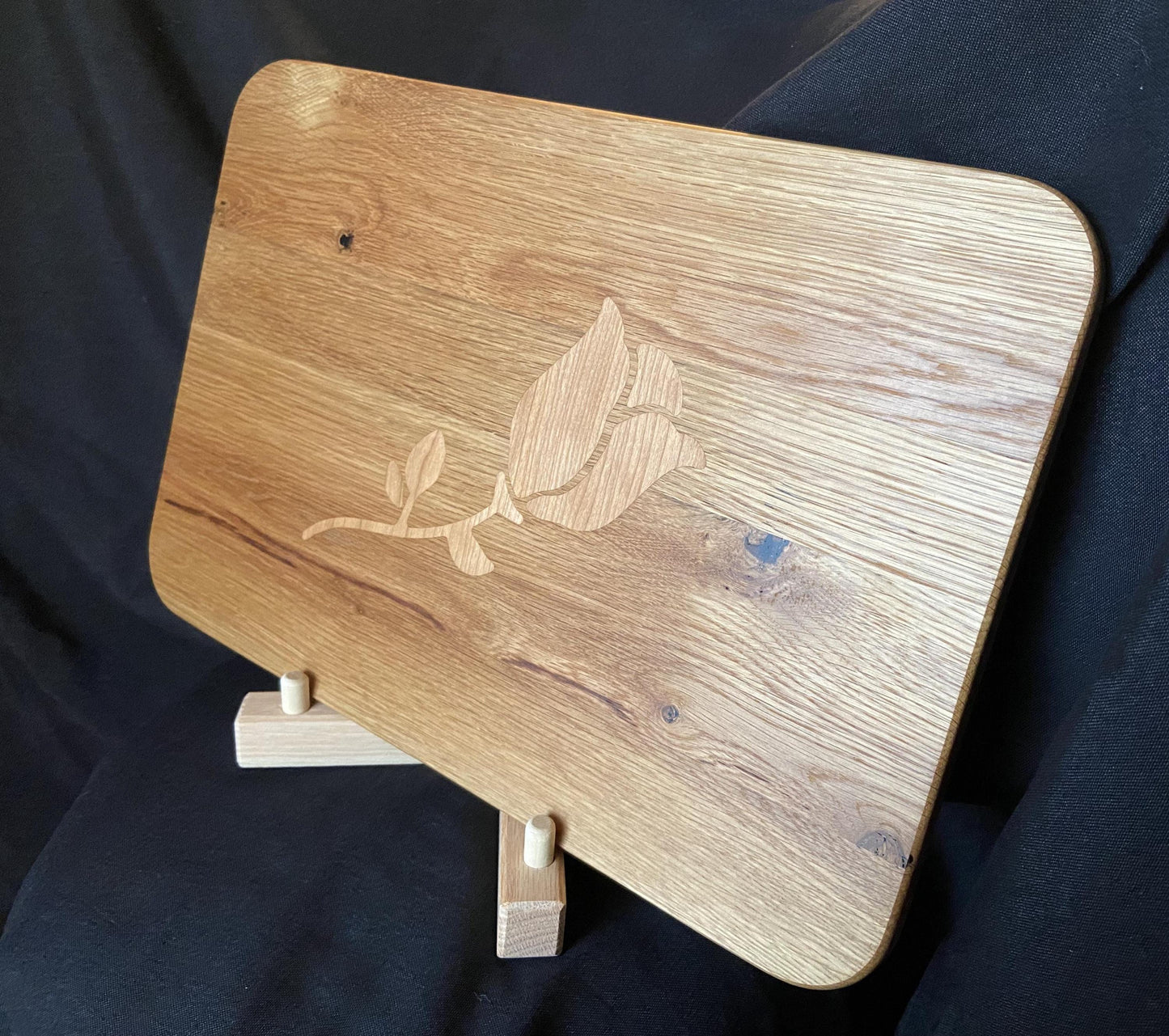 White Oak charcuterie board with subtle rose and stem inlay made from Cherry.