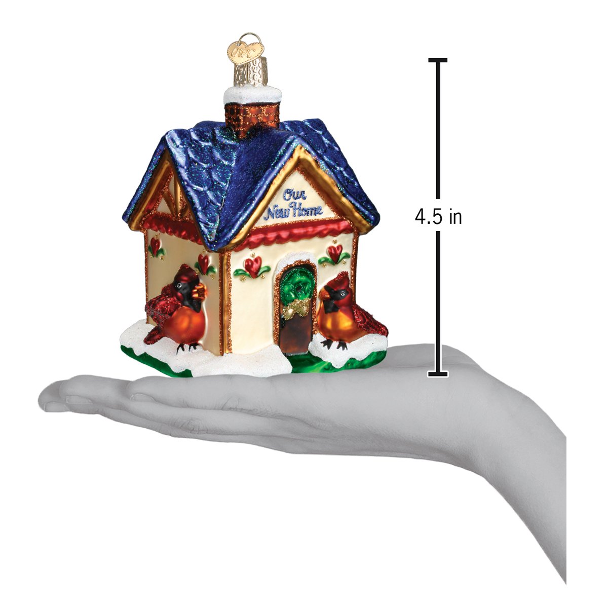 Our New Home Ornament displayed in a hand, showcasing its charming design and festive details.