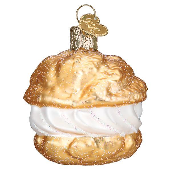 Glass ornament shaped like a pastry with white filling on a white background