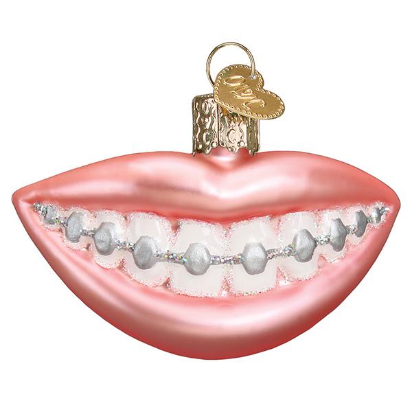 Decorative ornament shaped like lips with braces on a white background