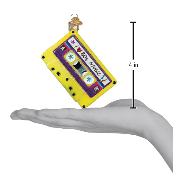 I Love The 80s Ornament depicted as a colorful cassette tape held in hand, celebrating 80s music nostalgia.