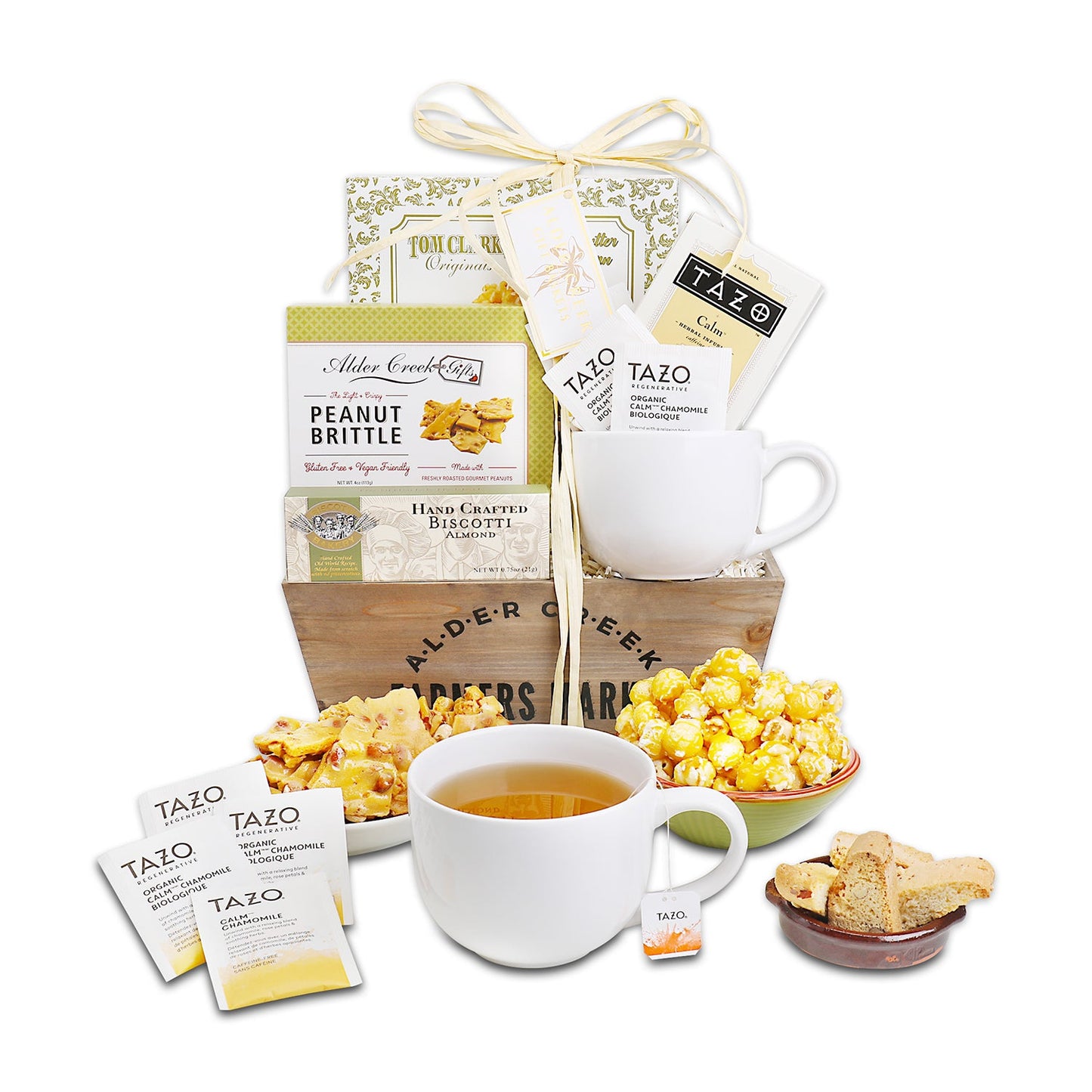 Tea gift basket with Tazo tea, popcorn, and cookies on a white background