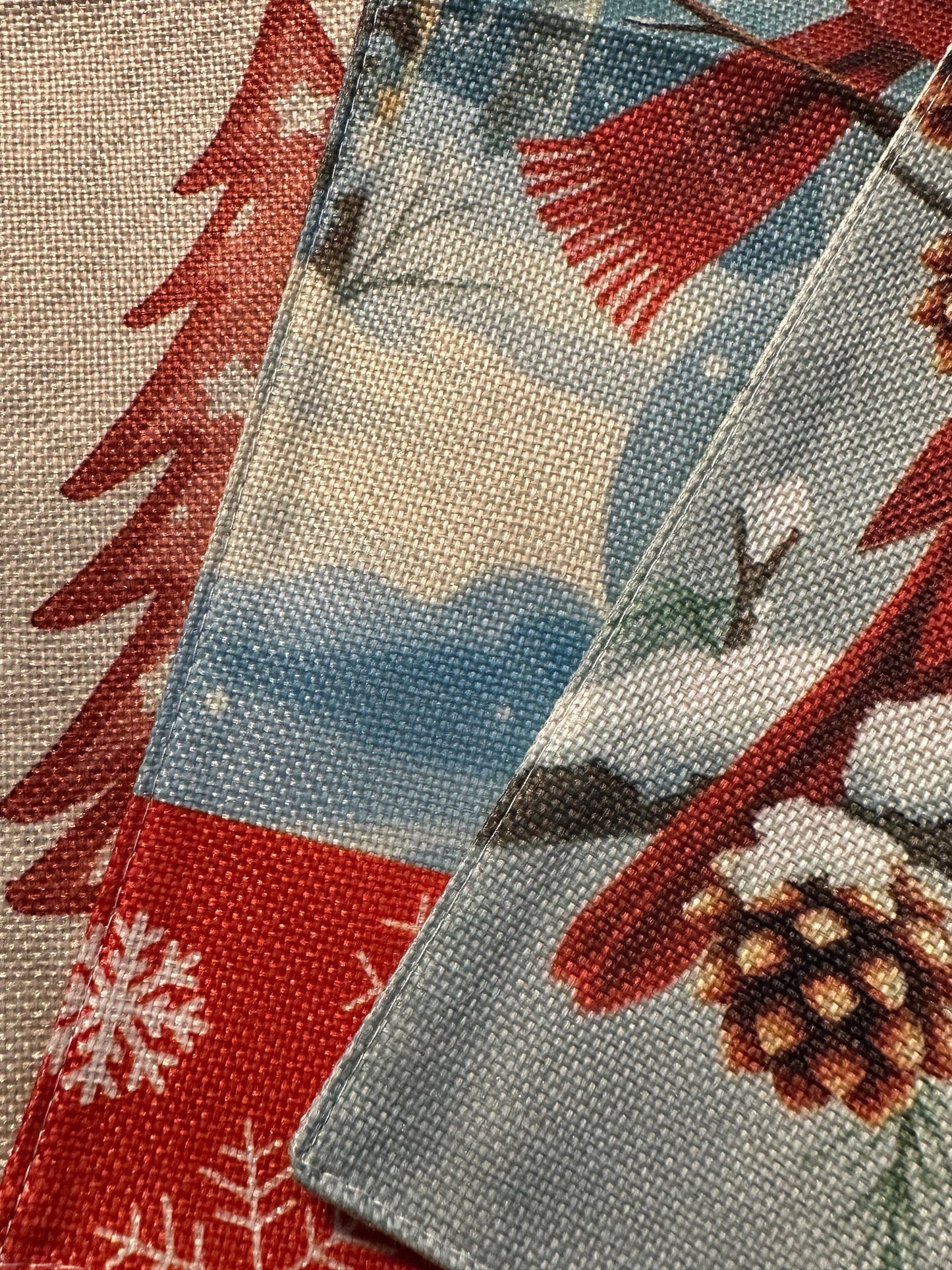 Close-up of the Let It Snow Red Barn Garden Flag showcasing festive winter patterns and textures.