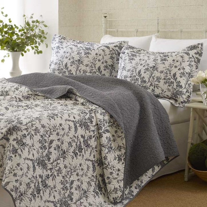 King Cotton Blend 3-Piece Reversible Quilt Set Grey White Floral on a bed with matching pillows and floral design.