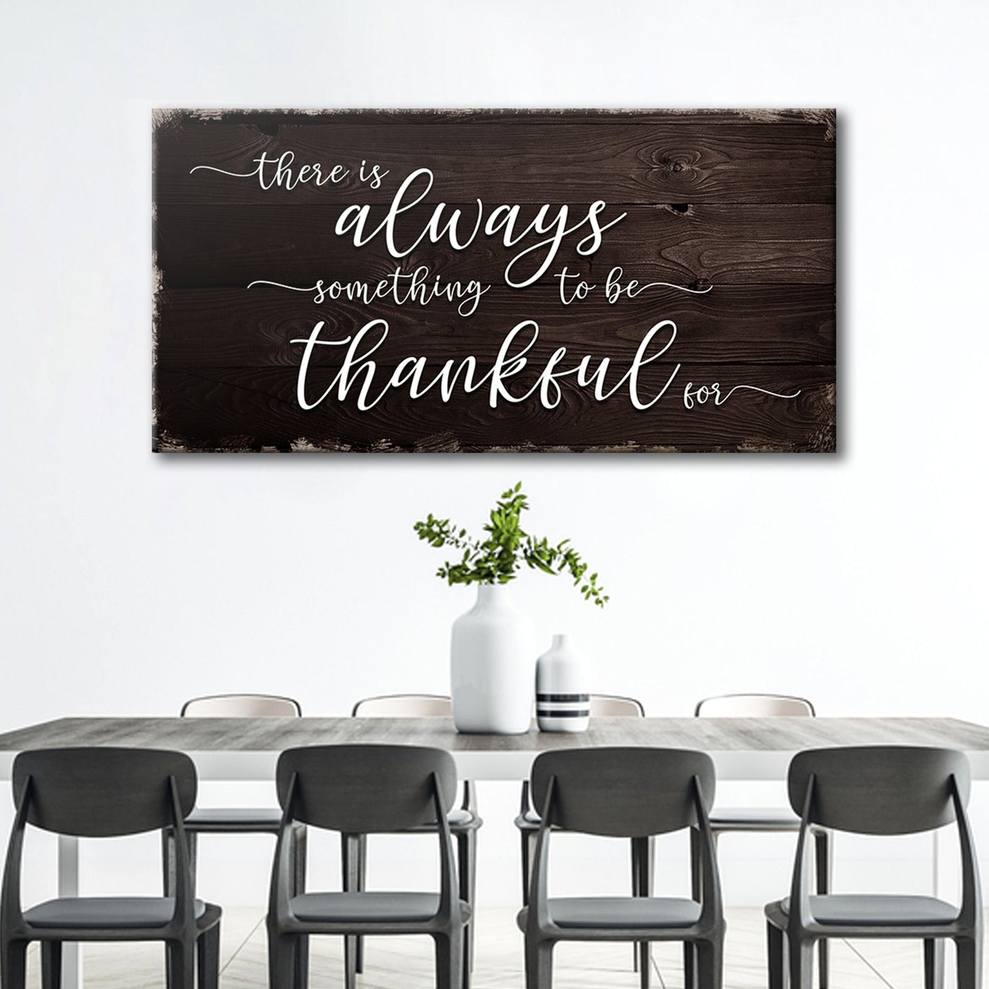 Dining room with a wooden wall sign that reads 'There is always something to be thankful for'.