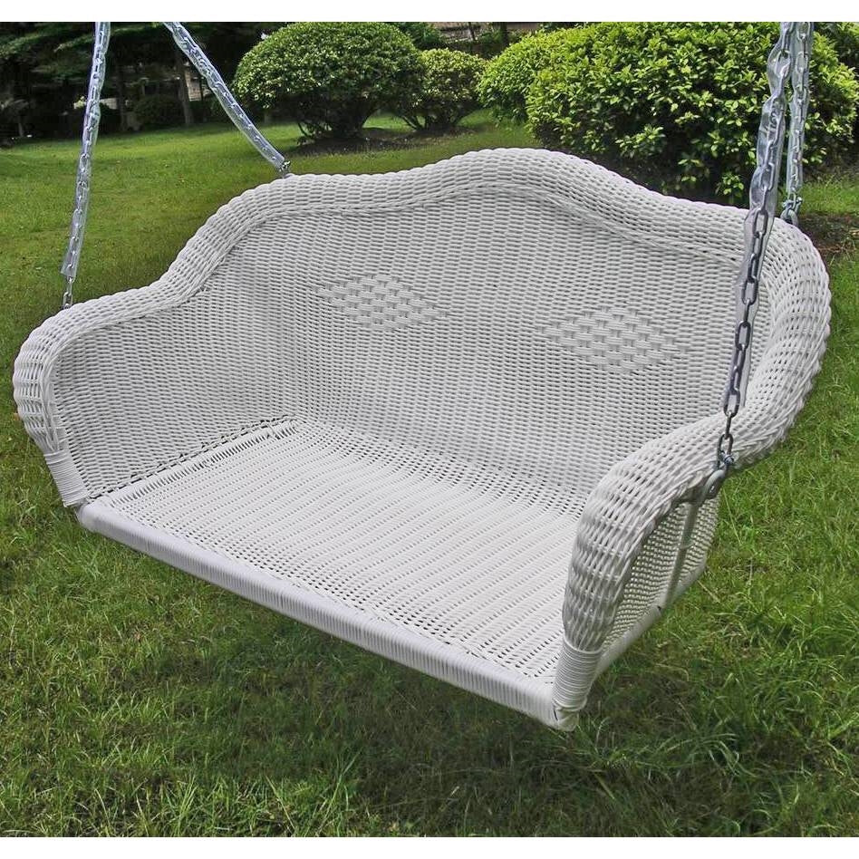 White Resin Wicker Porch Swing with 4-ft Hanging Chain on a grassy area, perfect for outdoor relaxation.