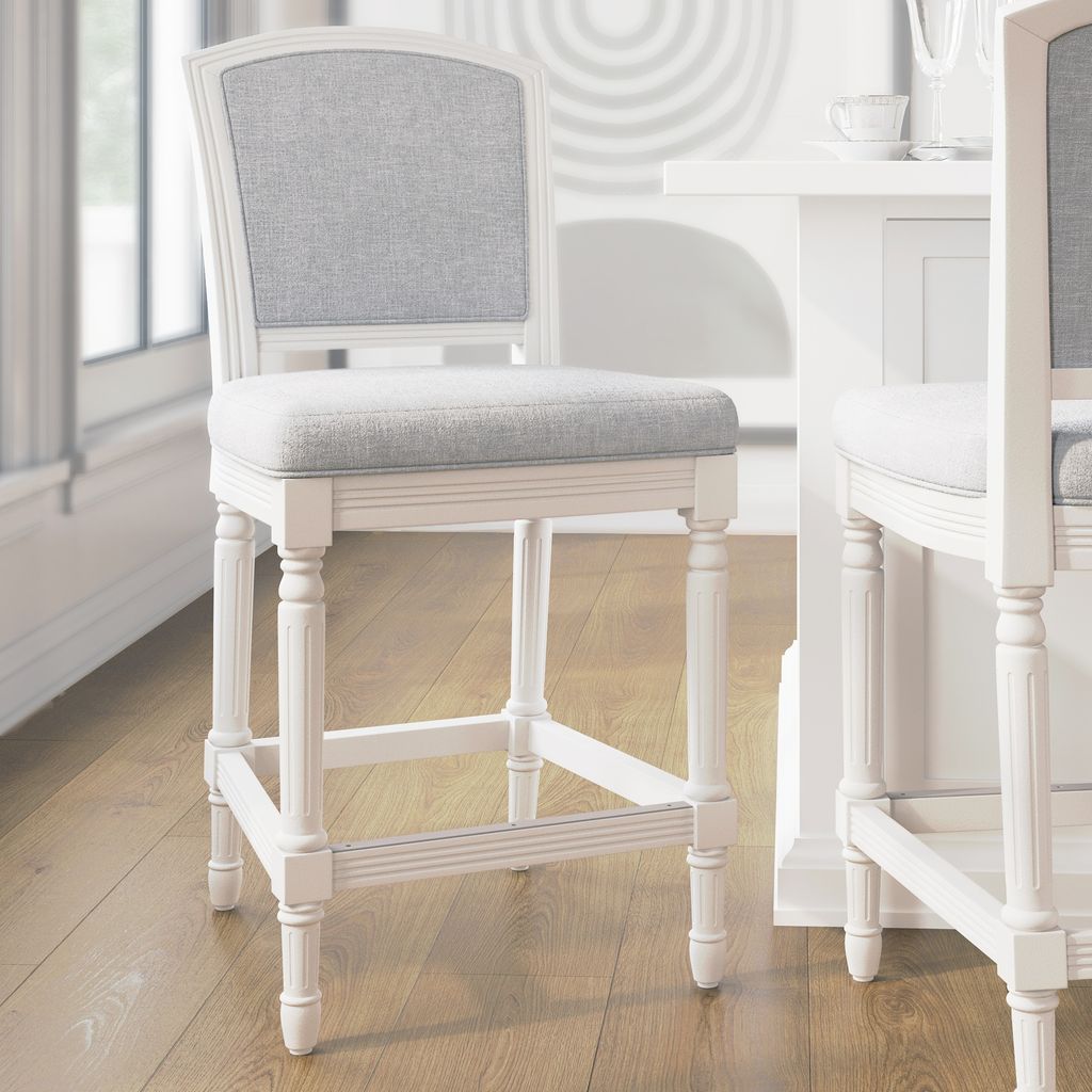 Wilmington Stool In White with plush fabric seat and backrest, solid wood frame, and hand-turned legs.