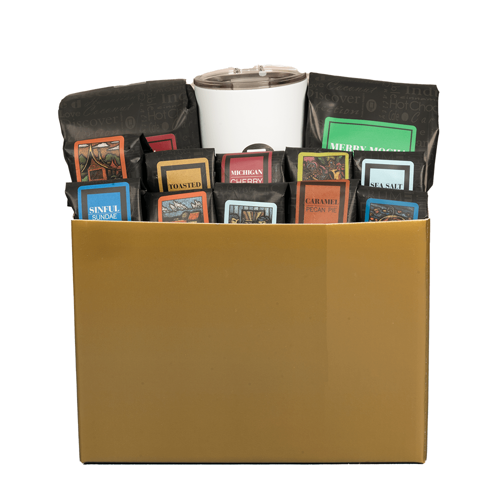 Collection of coffee bags with a white tumbler in a brown box on a transparent background