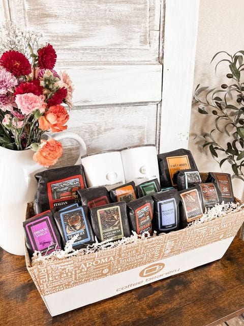 The VIP Coffee Gift Basket featuring assorted gourmet coffee bags and two travel mugs in a beautifully arranged box.
