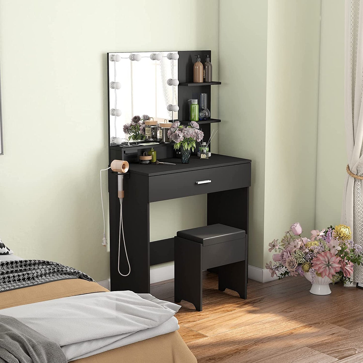 Black Makeup Vanity Table With Lighted Mirror And USB Ports in modern bedroom setup with flowers and beauty products.
