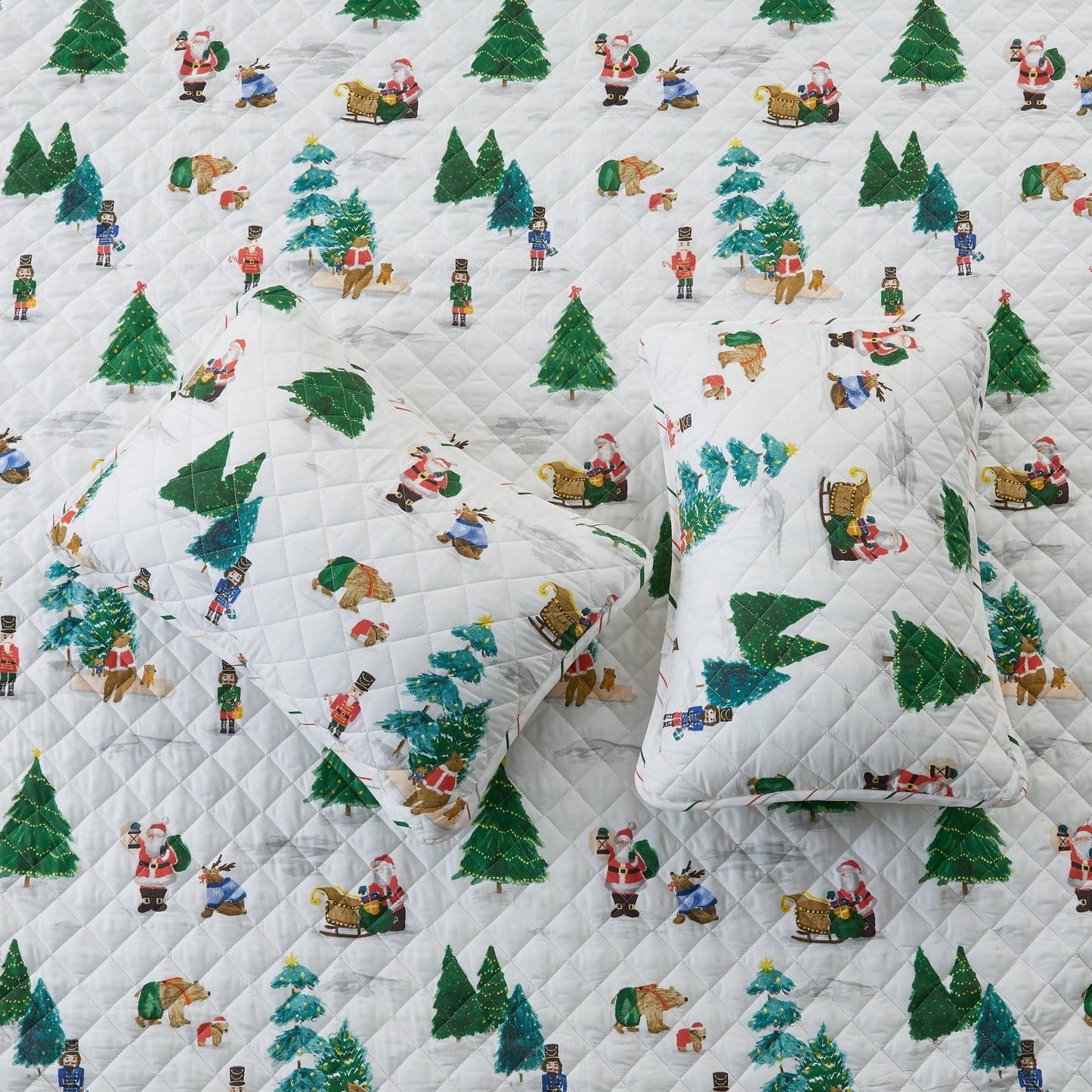 Quilt with Christmas-themed pattern featuring trees, Santa Claus, and reindeer on a white background.