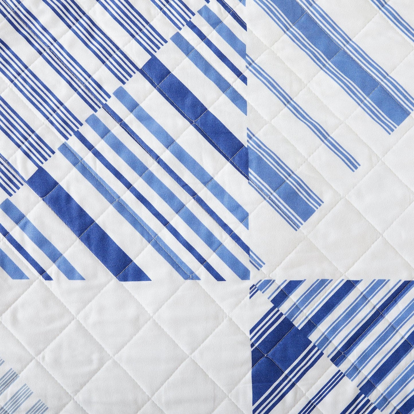 Quilt with blue and white striped pattern