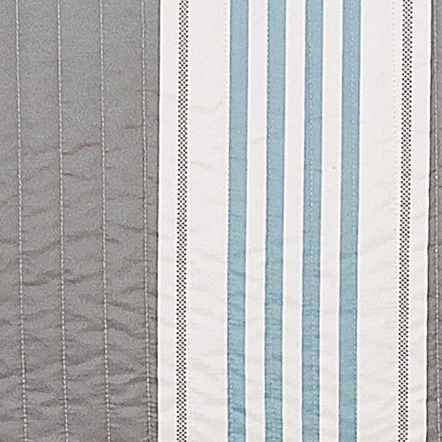 Striped fabric pattern with blue, gray, and white colors.