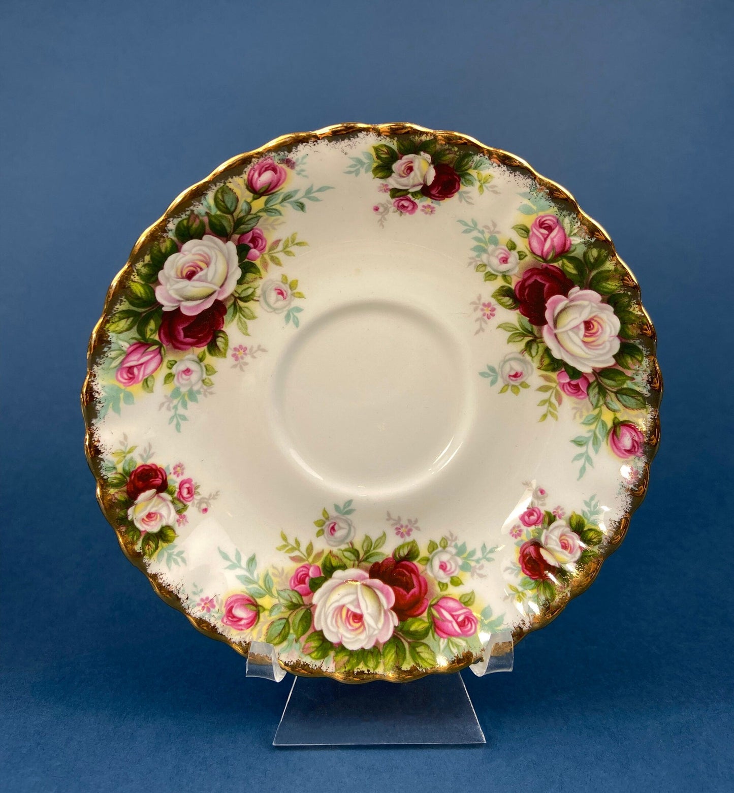 Decorative ceramic saucer with floral design on a blue background