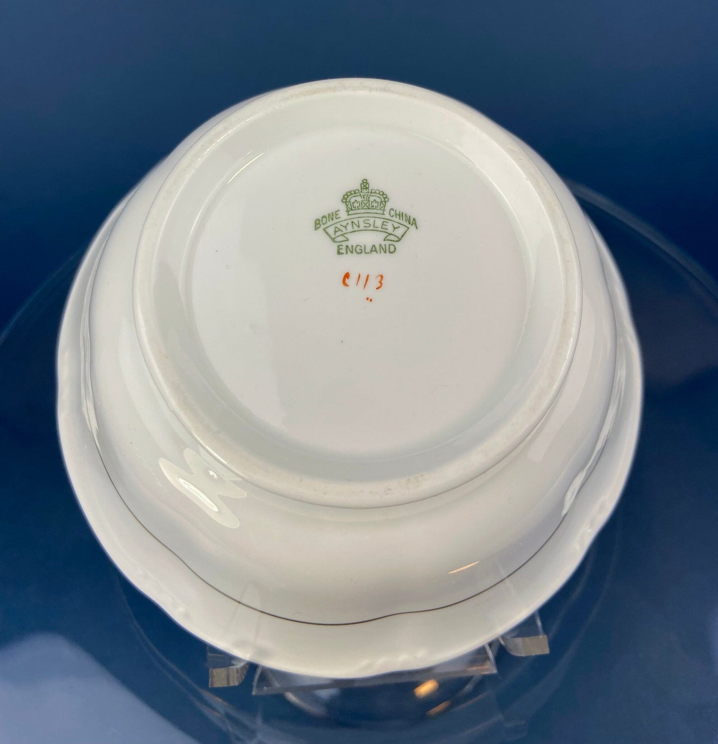 White ceramic item with a visible brand logo on a blue background