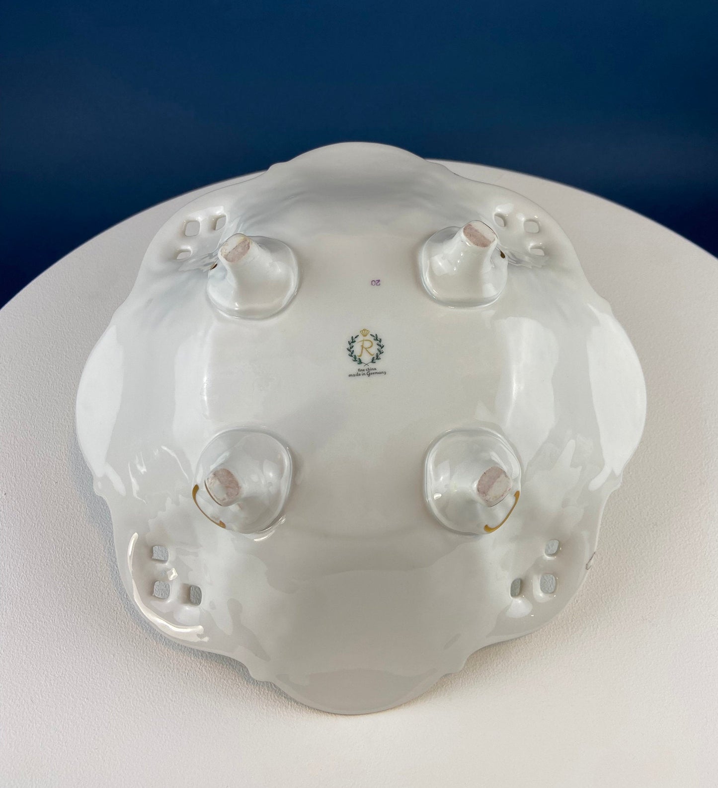 White porcelain dish with decorative design on a blue background