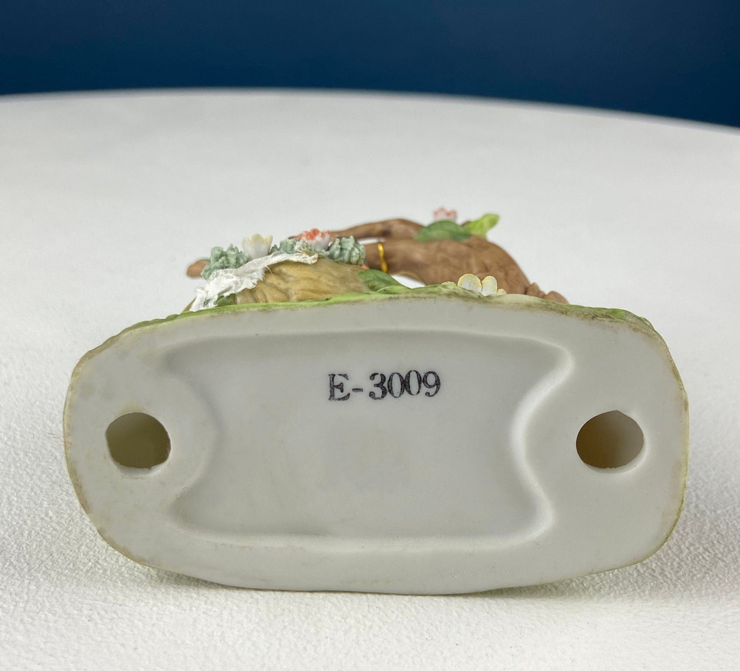 Decorative ceramic figurine with floral design on a white surface