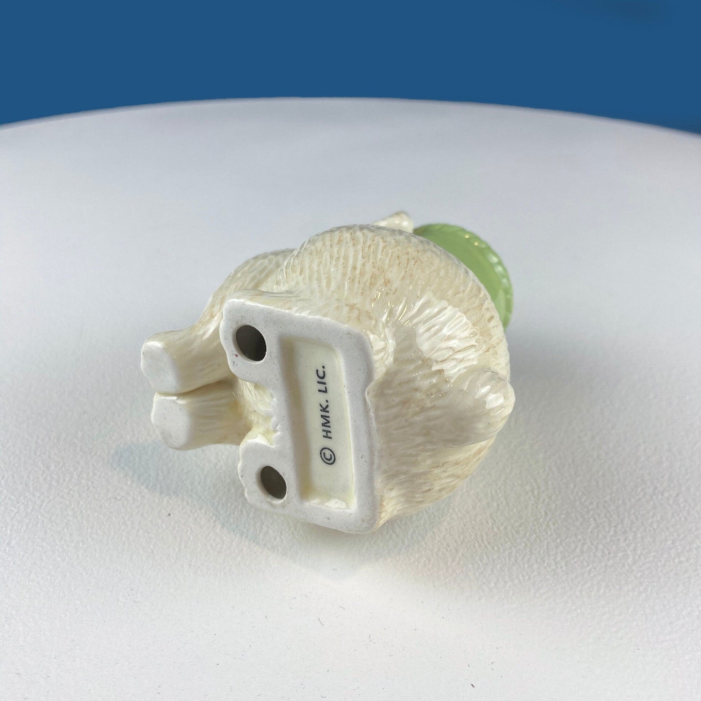 Model of a bunny on a white surface with a blue background