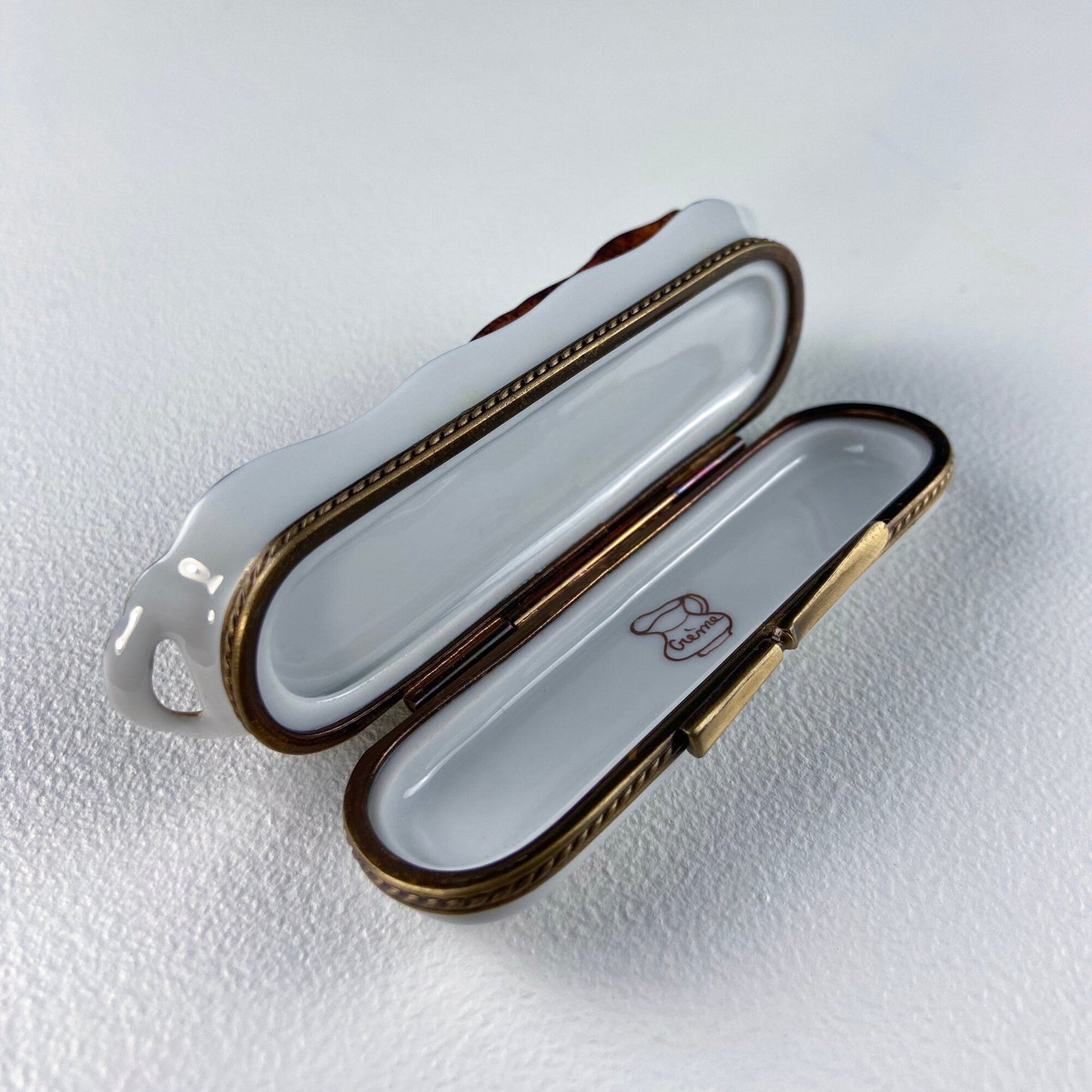 Open jewelry box with gold accents on a white background