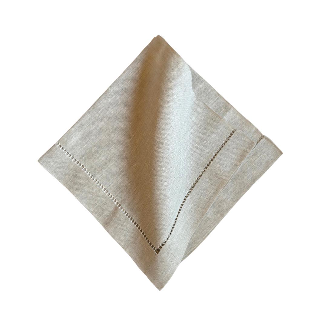Beige napkin with hemstitching on a white background