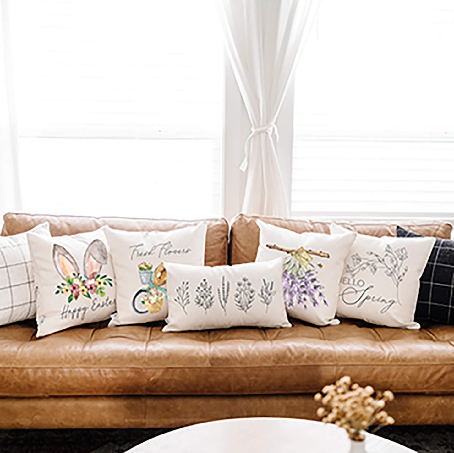 A cozy sofa adorned with various decorative pillows including the Hanging Lavender Spring Pillow Cover.