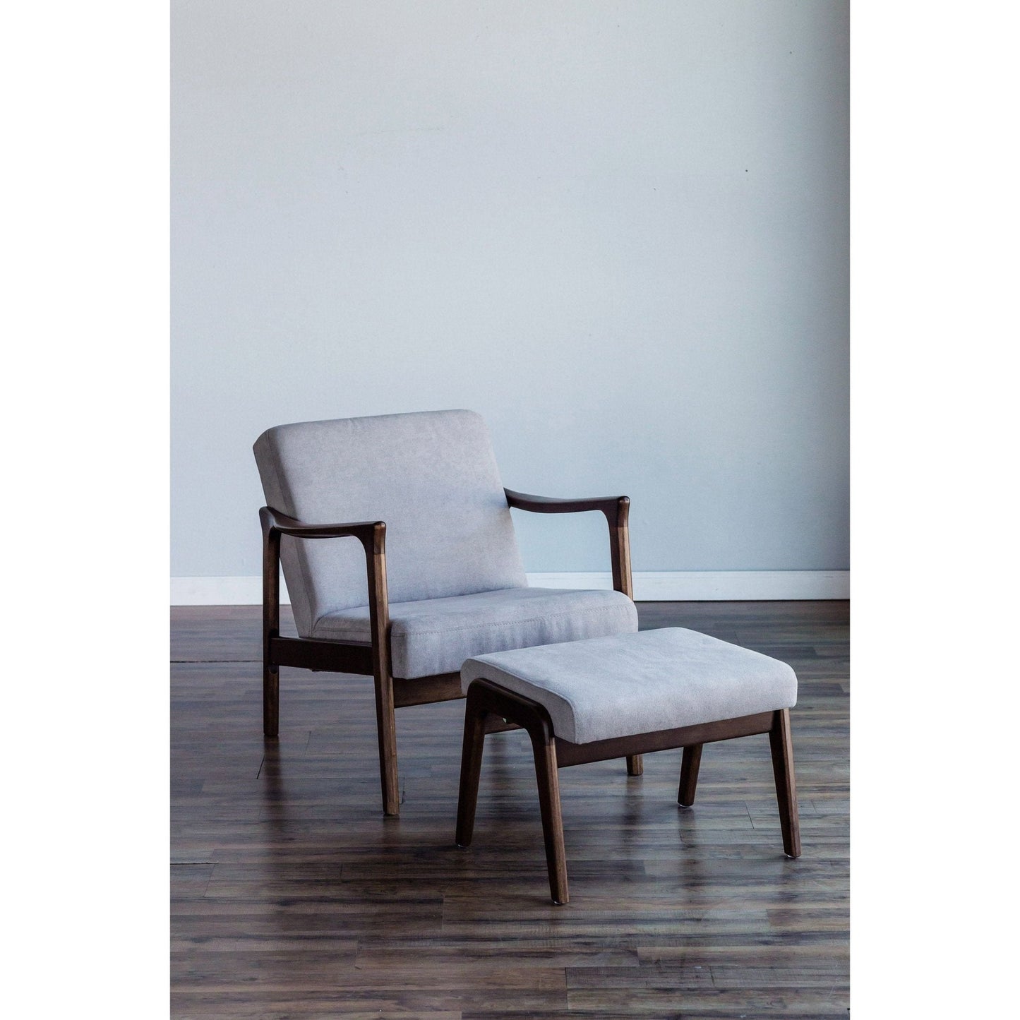 Zephyr Slate Footrest accompanied by a matching lounge chair in light gray upholstery and medium brown wood frame.
