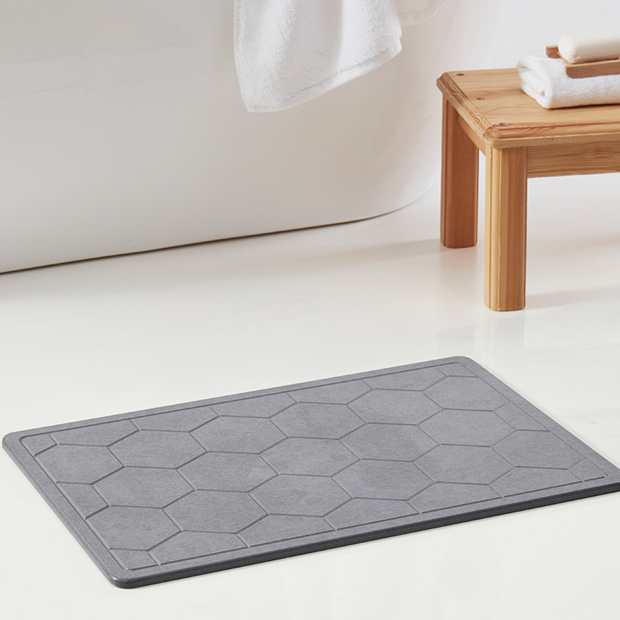 Stylish gray hexagon bath mat placed on a bathroom floor, perfect for enhancing your Bath Mats collection.