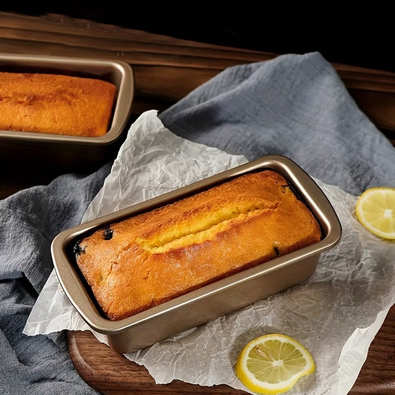 Freshly baked loaf in a bread pan with lemon slices beside it, showcasing perfect Bread Pans for home baking.