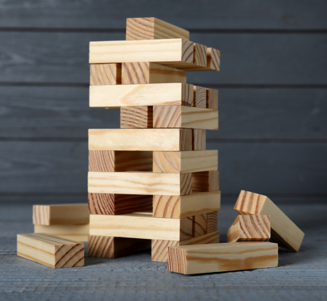 Stack of wooden blocks from a classic Board Game set on a rustic wooden surface.