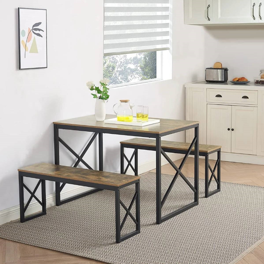 Industrial Kitchen table and benches set in a modern design, featuring wooden tops and black metal frames.