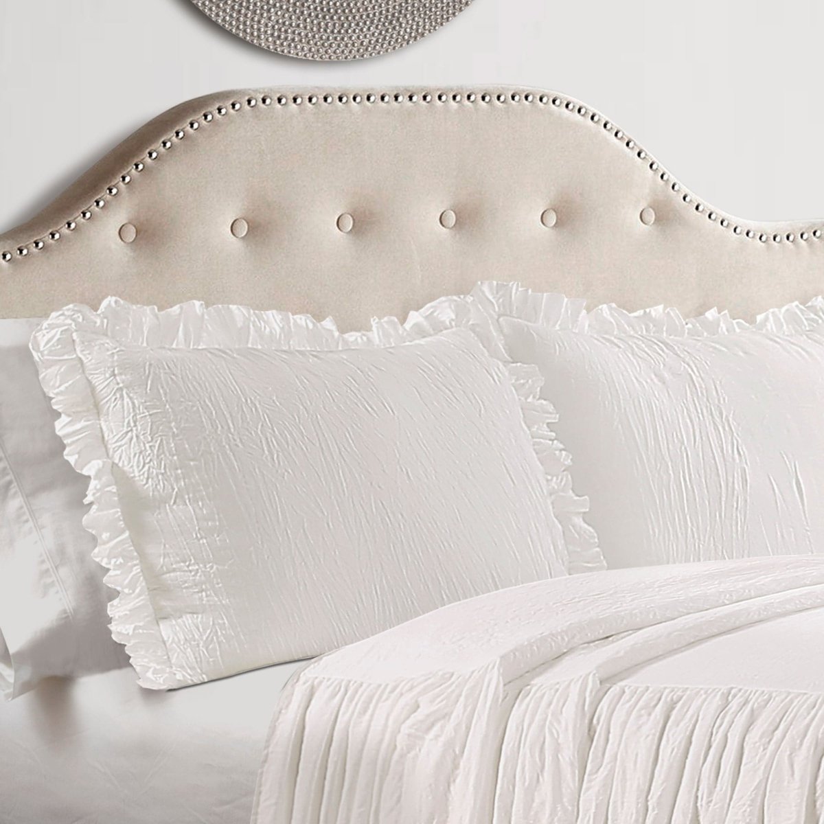 Upholstered Headboards with plush white pillows and elegant ruffled edges in a cozy bedroom setting.