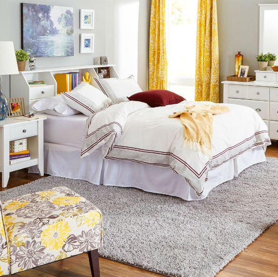 Traditional Kids' Bedroom featuring a cozy bed with decorative pillows and vibrant yellow accents.