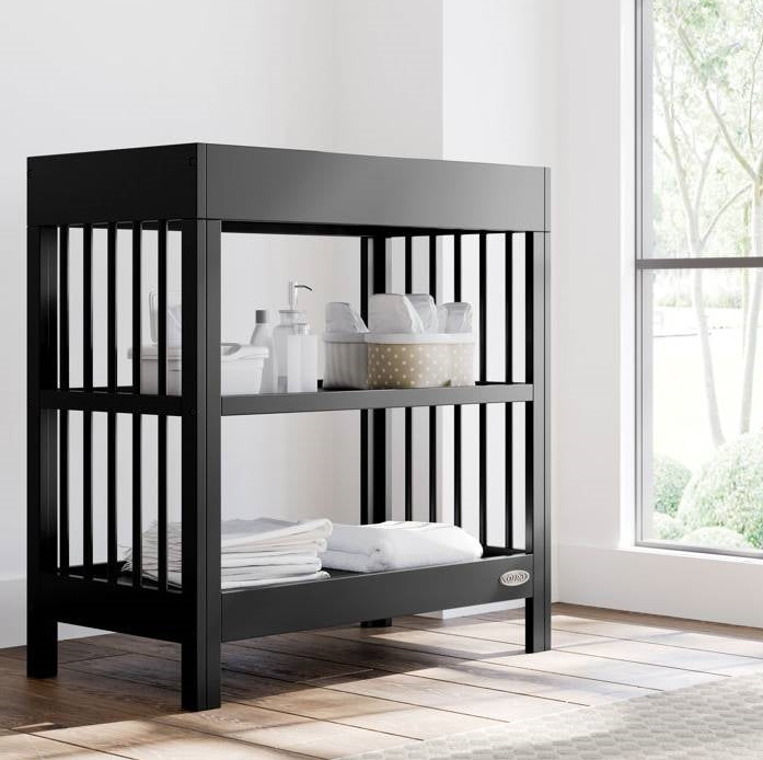 Stylish black baby changing table in a bright room, perfect for a Minimalist Nursery.
