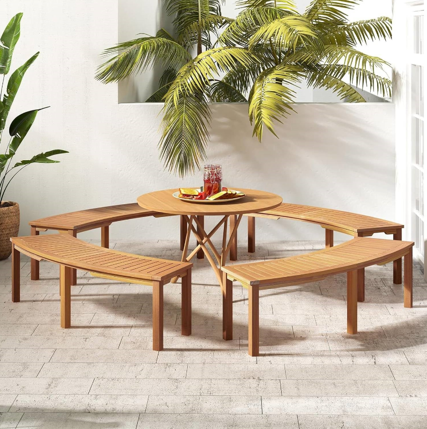 Mission Patio outdoor dining set featuring a circular table and curved benches in a tropical setting.