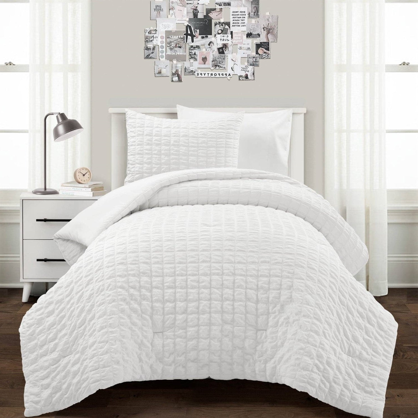 Contemporary Kids' Bedroom featuring a cozy white quilt and stylish wall art.