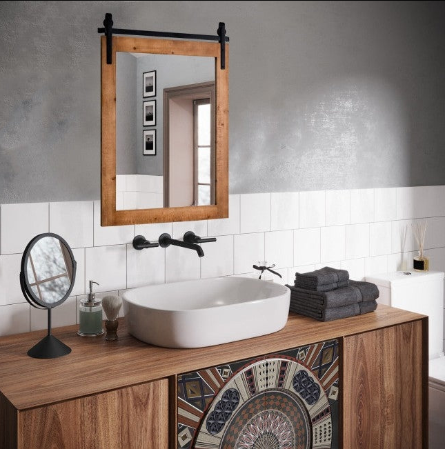 Rustic Bathroom featuring a wooden mirror, stylish basin, and decorative cabinetry with modern towels and accessories.