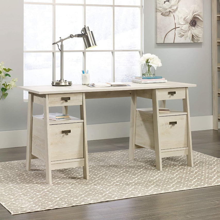 Farmhouse Home Office desk with modern design, lamp, and decorative elements, featuring organized drawers.