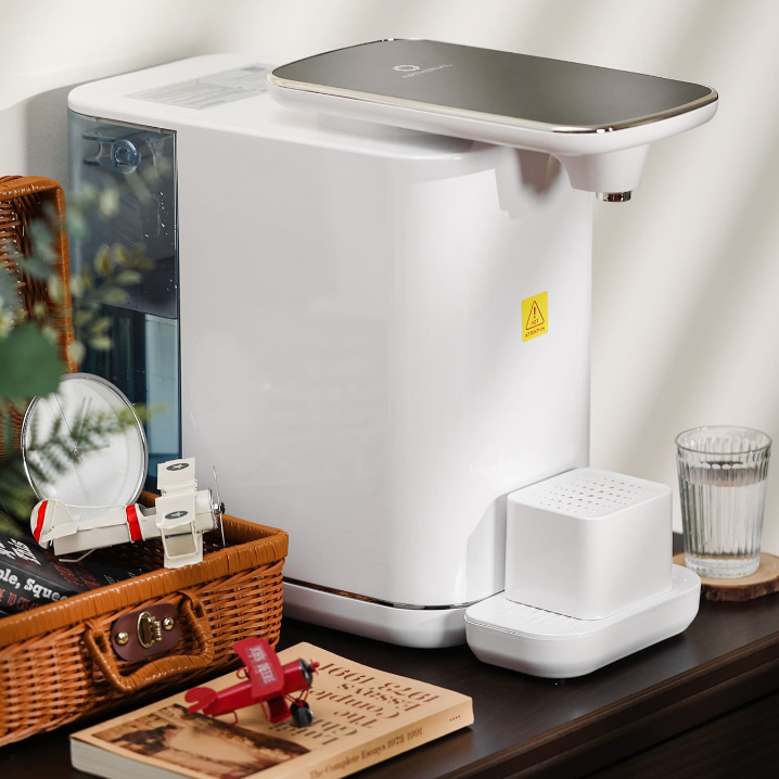Modern water dispenser with a sleek design and adjacent glass for easy hydration.