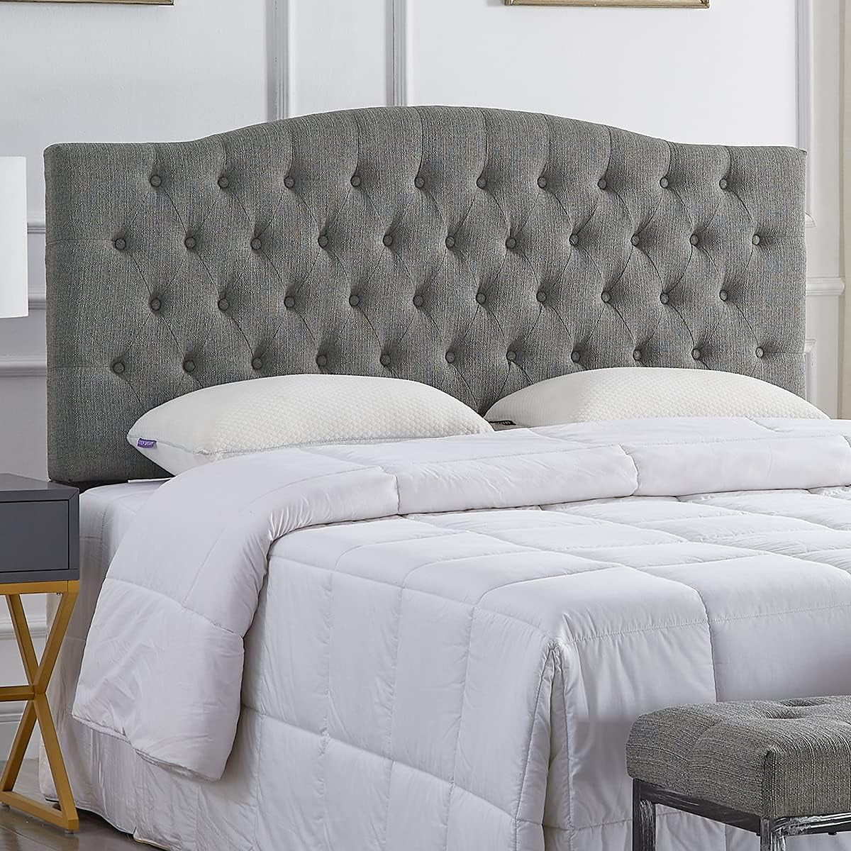Grey tufted fabric headboard on a bed showcasing stylish headboards collection.