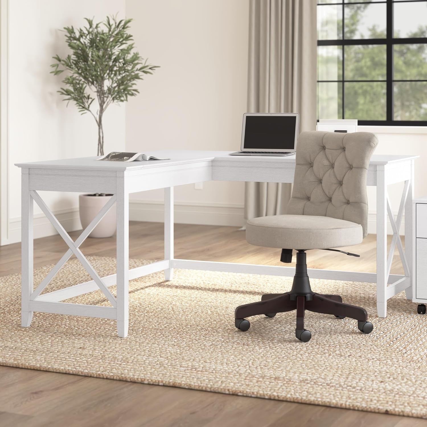 L-Shaped Desks featuring a modern design with a white finish and a comfortable chair in a bright office space.