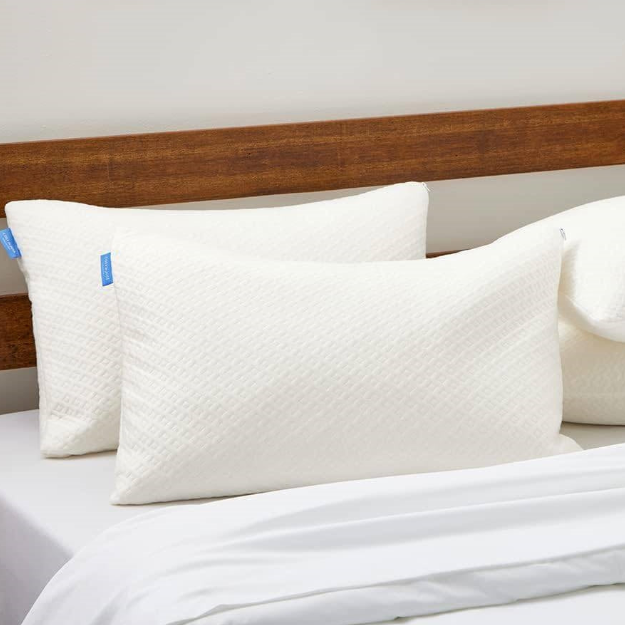 Two soft and inviting bed pillows arranged on a crisp white bed.