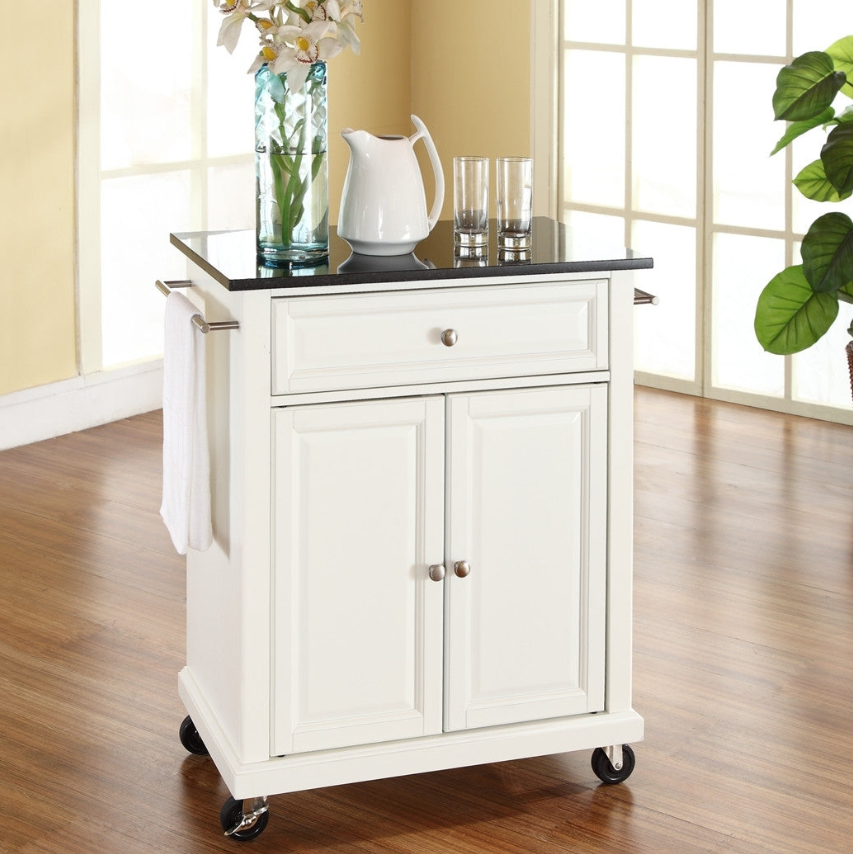 Traditional Kitchen white kitchen cart with black top, glasses, and a pitcher, perfect for entertaining.