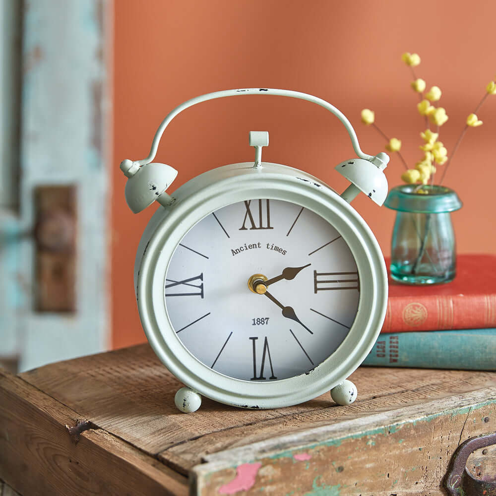 Vintage alarm clock with a white face and metal frame, perfect for any room décor. Alarm Clocks.
