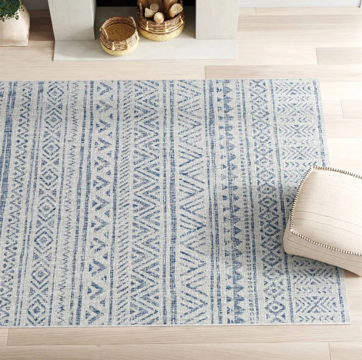 A stylish area rug featuring a blue geometric pattern, perfect for a Boho Living Room.