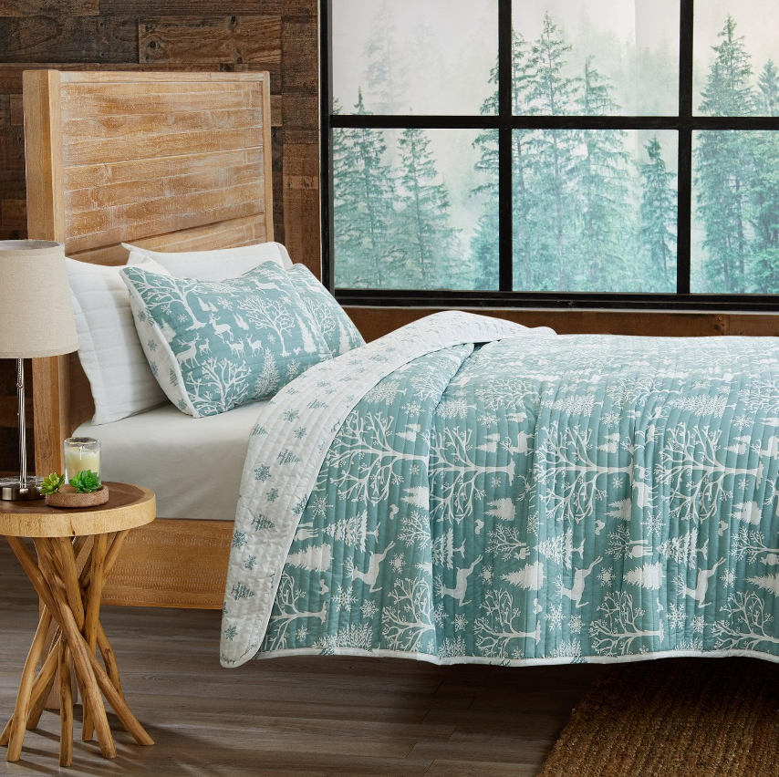 Rustic Kids' Bedroom featuring a cozy quilt and decorative pillows in a serene woodland setting.