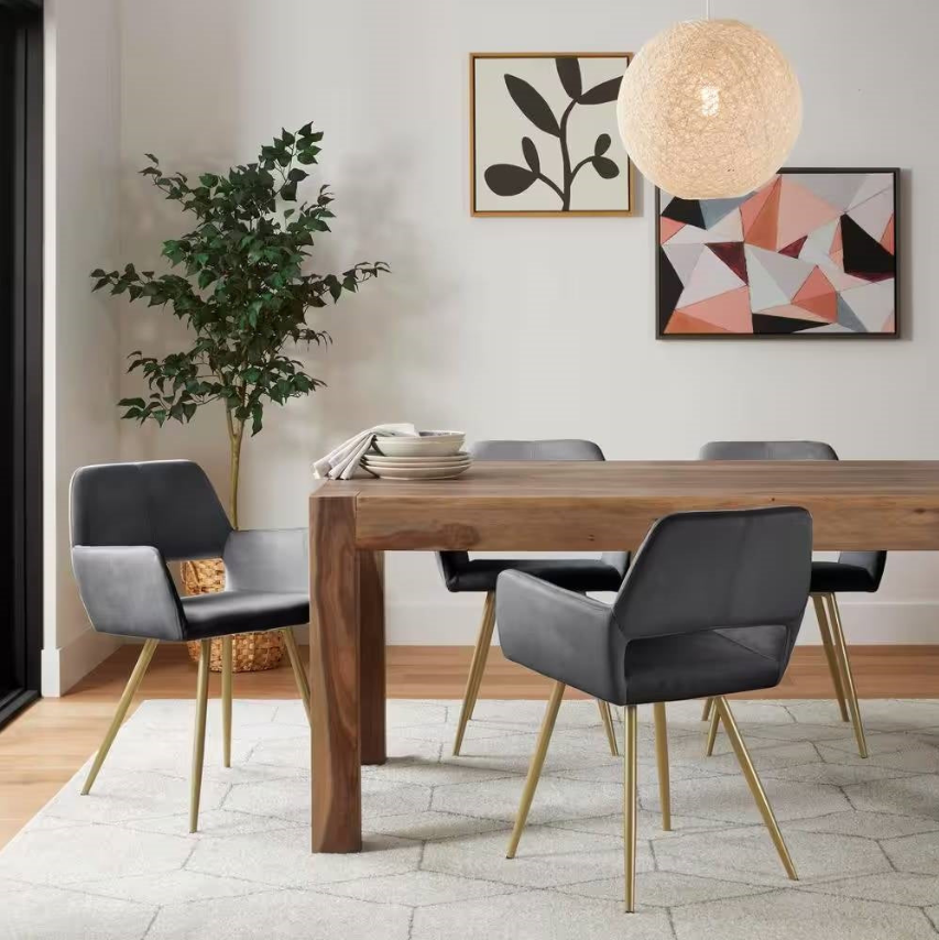 Contemporary Dining Room featuring sleek chairs and a wooden table with decorative art and plants.