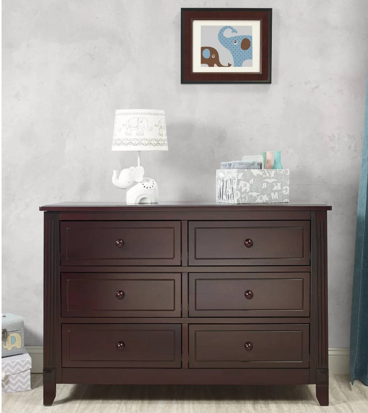 Contemporary Nursery with a dark wood dresser, elephant-themed lamp, and decorative frame on the wall.