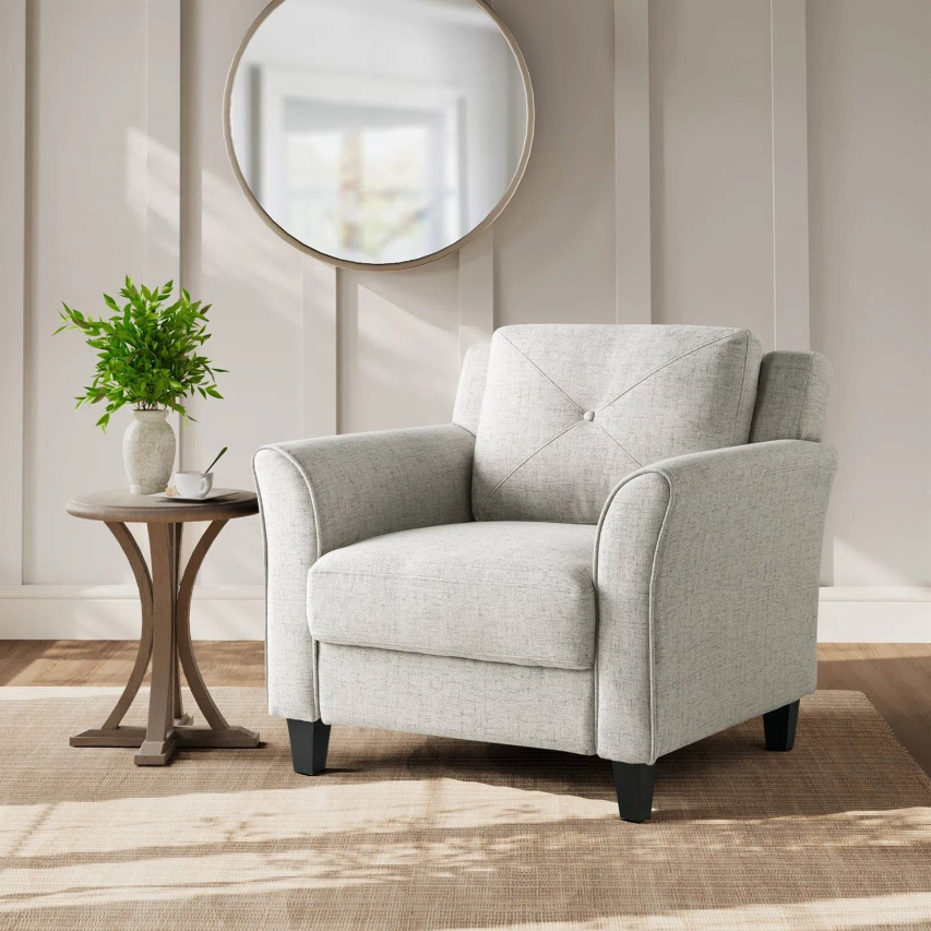 Traditional Living Room featuring a cozy gray armchair and side table with a plant.