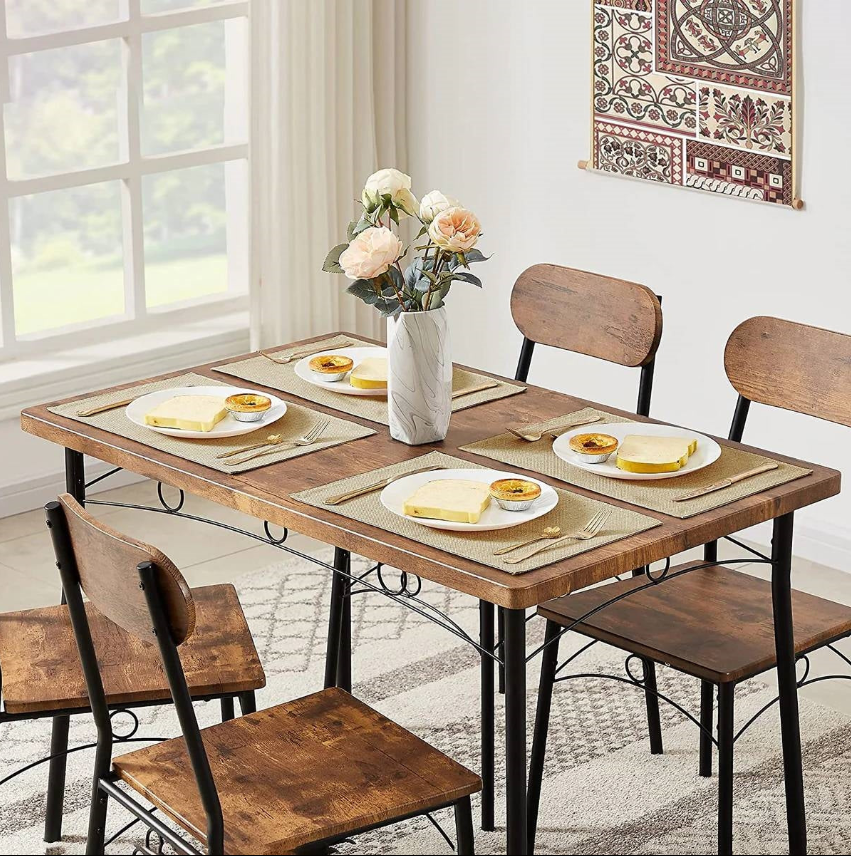 Industrial Dining Room set with wooden table, metal chairs, and flower vase in a bright space.