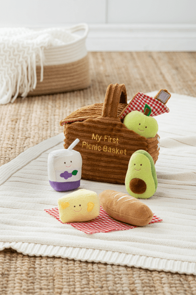 Colorful soft toys in a picnic basket, ideal as Toys for Ages 3 and Up for imaginative play.